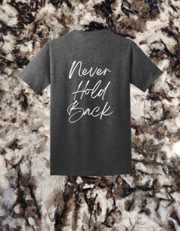 The back of a dark heather grey t-shirt displaying the 'Never Hold Back' quote in an elegant white script.